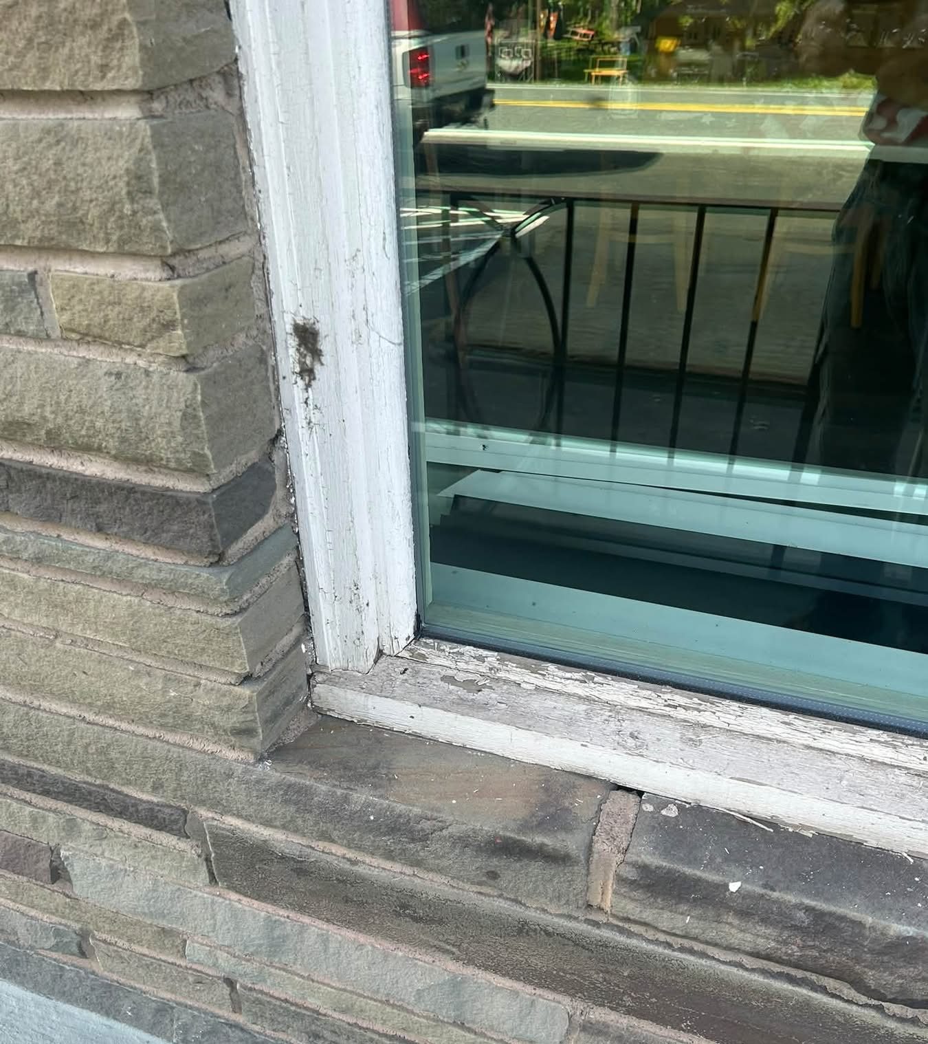 worn and damaged window frames of first place cafe