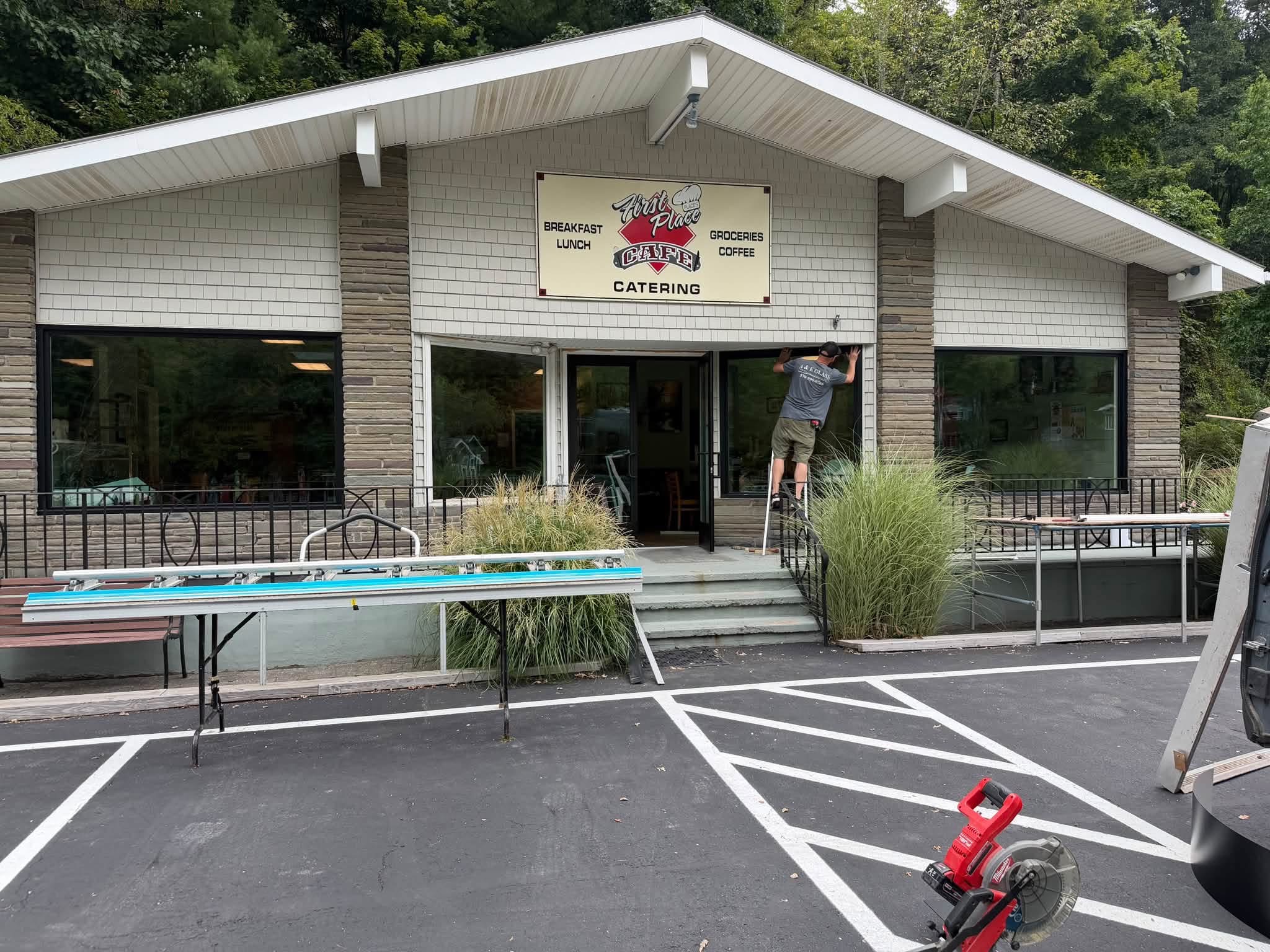 volunteer for bedco commercial property improvement program working on the front entrance of first place cafe